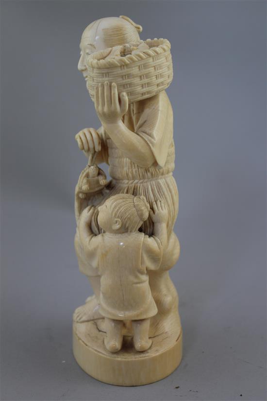 A Japanese ivory group of a fisherman and a boy, early 20th century, 13.5cm, age cracks